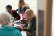 © Tom Merton/Caia Image - Senior business people working, using digital tablets in conference room meeting