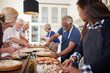 © Trevor Adeline/Caia Image - Senior friends making pizzas in cooking class