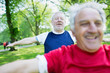 © Tom Merton/Caia Image - Active senior men exercising, stretching in park