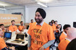 © Sam Edwards/Caia Image - Happy, confident hacker in turban coding for charity at hackathon