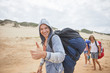 © Trevor Adeline/Caia Image - Portrait confident man with paragliding parachute backpack on beach