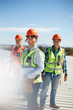 © Trevor Adeline/Caia Image - Portrait smiling, confident engineers at sunny power plant