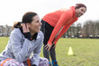 © Sam Edwards/Caia Image - Man and woman exercising in park