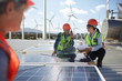 © Trevor Adeline/Caia Image - Engineers examining solar panels at alternative energy power plant