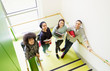 © Rob Daly/Caia Image - Portrait smiling high school students on stair landing