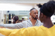 © Sam Edwards/Caia Image - Focused male instructor guiding student in dance class studio