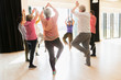 © Tom Merton/Caia Image - Active seniors exercising, practice yoga tree pose in circle