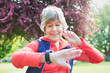 © Tom Merton/Caia Image - Active senior female runner checking smart watch in park