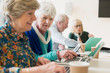 © Martin Barraud/Caia Image - Senior businesswomen using laptops in conference room meeting