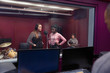 © Sam Edwards/Caia Image - Teenage musicians recording music, singing in sound booth