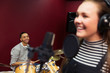 © Sam Edwards/Caia Image - Smiling teenage musicians recording music, signing playing drums in sound booth