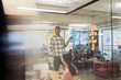© Sam Edwards/Caia Image - Creative businessman leading brainstorming meeting, using adhesive notes in office