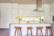 © Charlie Dean/Caia Image - Modern white kitchen with island and barstools