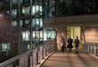 © Paul Bradbury/Caia Image - Business people walking on urban pedestrian bridge at night