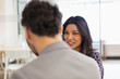© Martin Barraud/Caia Image - Smiling businesswoman talking with colleague in office