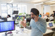 © Sam Edwards/Caia Image - Indian computer programmer in turban talking on smart phone in office