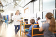 © Trevor Adeline/Caia Image - Teacher and students using touch screen computers