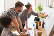 © Tom Merton/Caia Image - Creative designers discussing story board in office