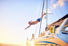 Young Man Diving Off Catamaran