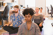 © Tom Merton/Caia Image - Serene creative business people meditating in office