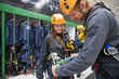 © Trevor Adeline/Caia Image - Man helping woman with zip line equipment