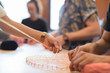 © Tom Merton/Caia Image - People doing string art project