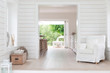 © Charlie Dean/Caia Image - White wood shiplap home showcase interior sitting area