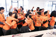 © Sam Edwards/Caia Image - Enthusiastic hackers celebrating, coding for charity at hackathon