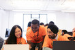 © Sam Edwards/Caia Image - Hackers at laptops coding for charity at hackathon