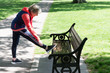 © Robert Daly/Caia Image - Active senior woman stretching leg on park bench