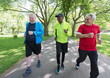 © Robert Daly/Caia Image - Active senior men friends power walking in park