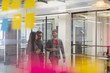 © Sam Edwards/Caia Image - Business people walking and talking in office corridor