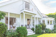 © Charlie Dean/Caia Image - Home showcase exterior white house with patio and garden
