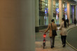 © Paul Bradbury/Caia Image - Business people with bicycle walking on urban sidewalk at night