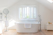 © Charlie Dean/Caia Image - Tranquil white home showcase bathroom with soaking tub