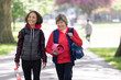 © Robert Daly/Caia Image - Active senior women friends with yoga mat walking in park