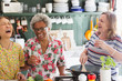© Tom Merton/Caia Image - Happy active senior women cooking in kitchen