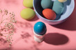 © Simonforstock - Easter eggs, flower and plate on pink background
