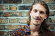 © Paul Bradbury/Caia Image - Portrait smiling, confident young male hipster with mustache