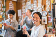 © Tom Merton/Caia Image - Portrait smiling creative businesswoman eating watermelon in office