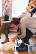 © Tom Merton/Caia Image - Creative businesswoman petting cute dog in office