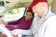 © Sam Edwards/Caia Image - Couple looking at map in car on road trip