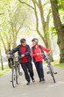 © Robert Daly/Caia Image - Active senior couple walking bicycles in park