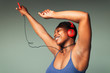 © Paul Bradbury/Caia Image - Carefree young woman with headphones and mp3 player dancing