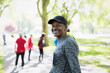 © Tom Merton/Caia Image - Portrait confident, happy senior man walking sports race in park