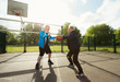 © Robert Daly/Caia Image - Active senior men friends playing basketball in sunny park