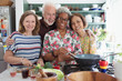 © Robert Daly/Caia Image - Portrait happy active senior friends cooking in kitchen