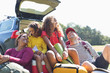 © Sam Edwards/Caia Image - Happy family with camping equipment at back of car