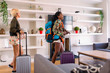 © Tom Merton/Caia Image - Young women friends with suitcases arriving at house rental
