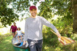 © Sam Edwards/Caia Image - Family carrying canoe in woods